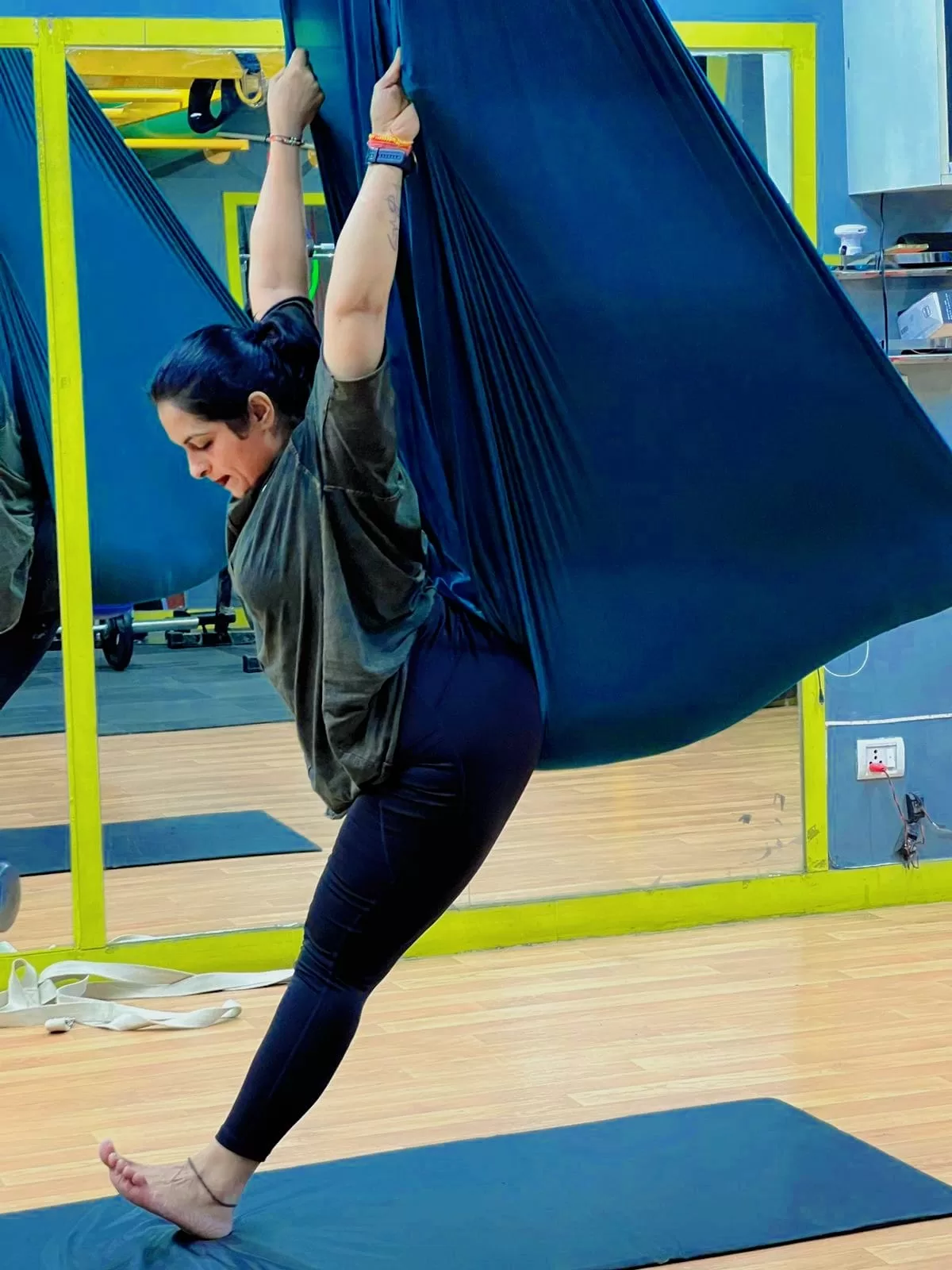 Female member doing aerial yoga at exclusive gym for women in Gurgaon